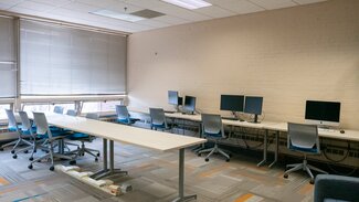 Computer lab with multiple work stations and printers