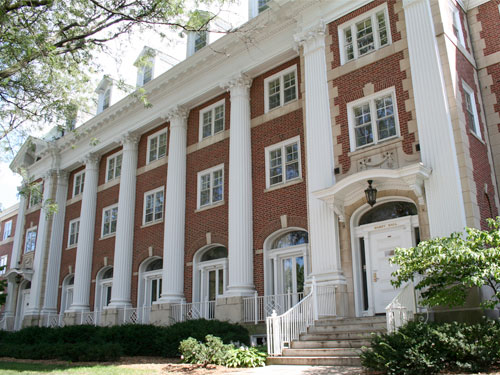 3-story red brick building with tall white pillars in front