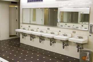 ISR bathroom with sinks, mirrors and shower stalls