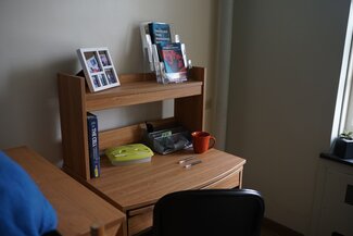 Desk at foot of bed with rolling chair