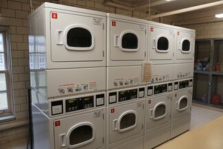 LAR laundry room with stacked dryers