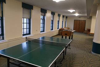 LAR Basement Lounge with ping pong table, foosball table, tables and chairs