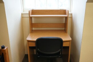Desk with chair in front of window