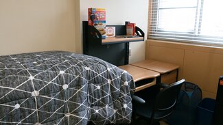 Desk at foot of bed with rolling chair