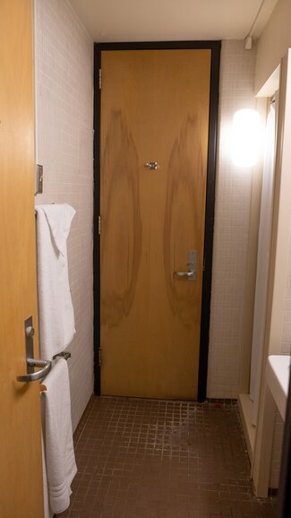 Sherman suite bathroom with door to adjoining room and towel rack