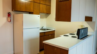 Apartment Kitchen with fridge, cabinets, counters, oven, stove, sink
