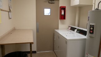 Laundry room with washer, dryer, and table